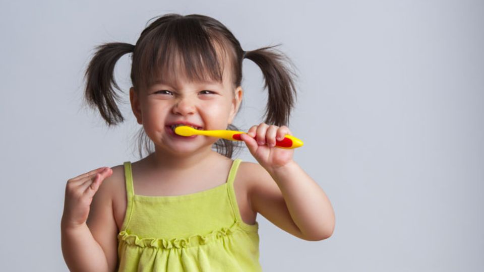 Small Child Brushing Her Teeth