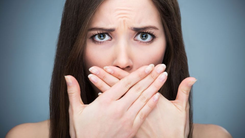 Woman Covering Her Mouth Due Bad Breath